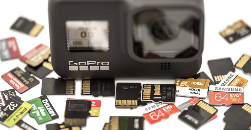 gopro camera next to scattered sd cards