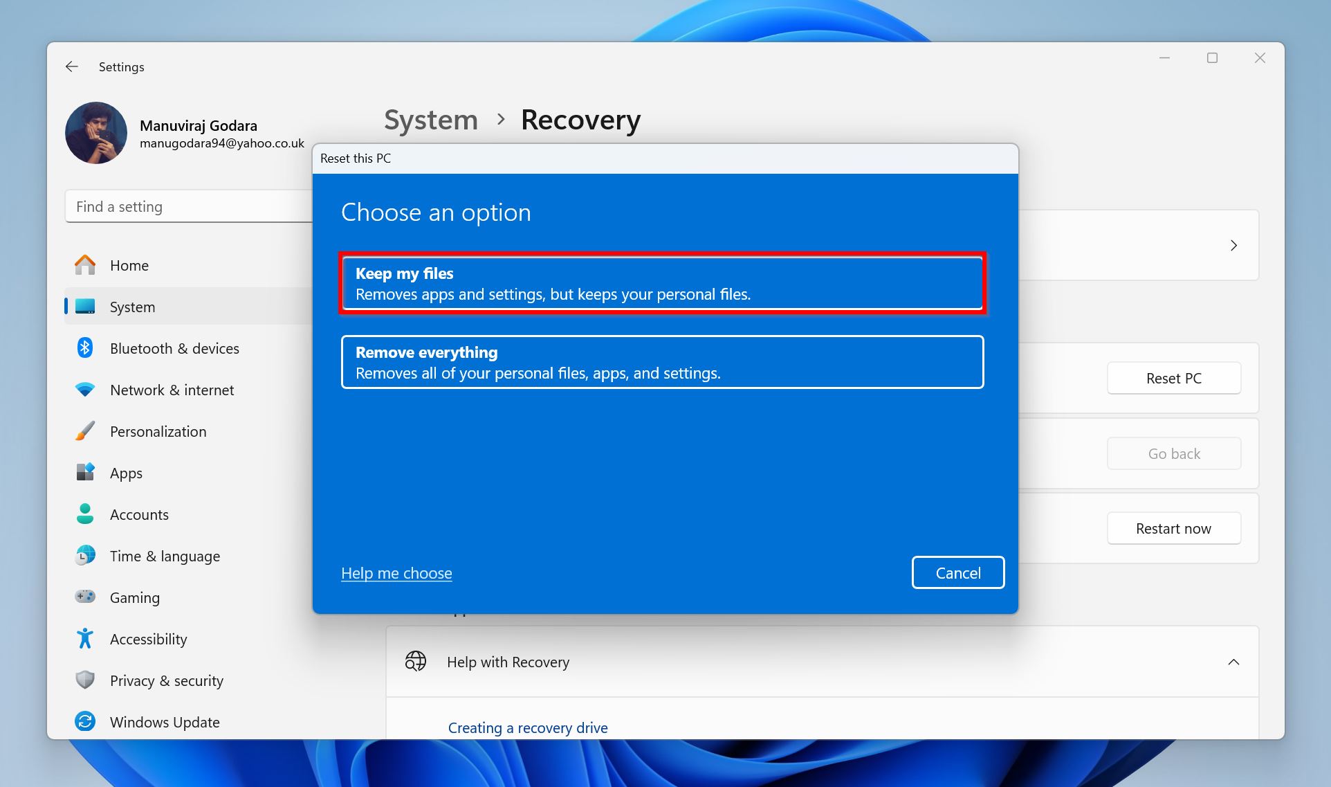 A Windows recovery screen with two main options framed in blue. The first, highlighted in red, is 'Keep my files' which removes apps and settings but keeps personal files. The second is 'Remove everything', which removes all personal files, apps, and settings.